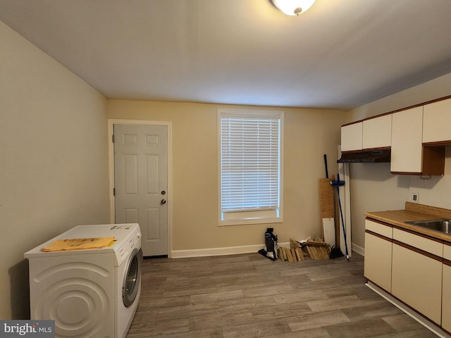 washroom featuring hardwood / wood-style flooring and cabinets