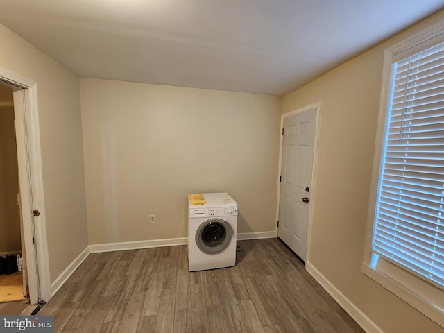 clothes washing area with washer / dryer and hardwood / wood-style flooring