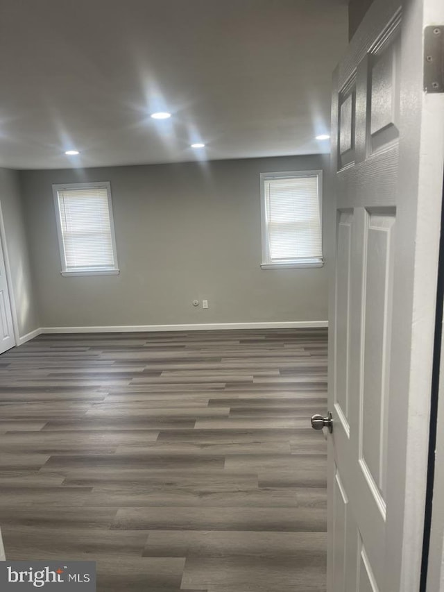 interior space featuring dark wood-type flooring and a healthy amount of sunlight