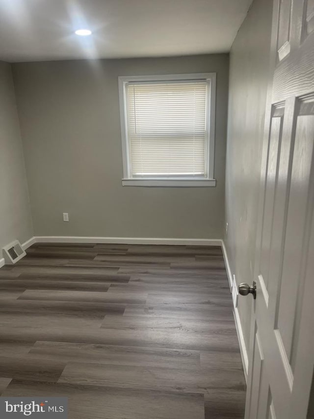 empty room with dark hardwood / wood-style floors