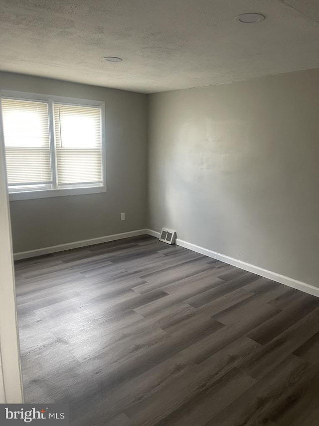 empty room featuring dark wood-type flooring