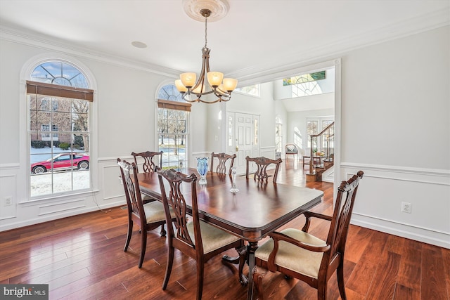 dining space featuring a notable chandelier, dark hardwood / wood-style floors, and crown molding