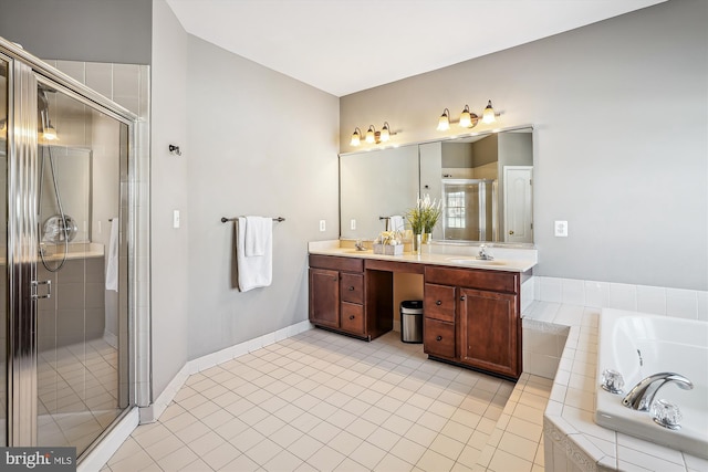 bathroom with tile patterned flooring, vanity, and shower with separate bathtub