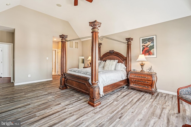 bedroom with hardwood / wood-style flooring, vaulted ceiling, and ceiling fan