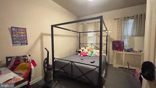 carpeted bedroom with vaulted ceiling