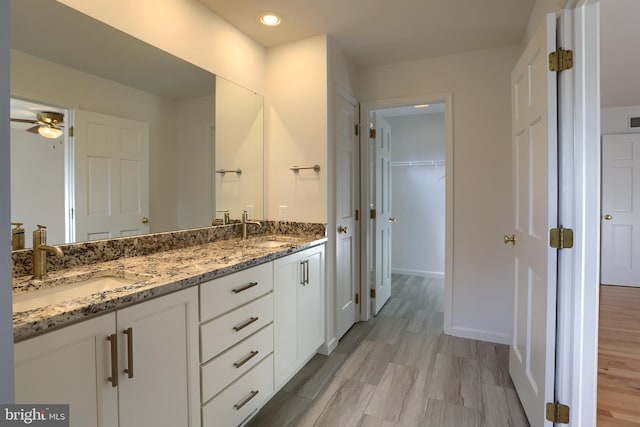 bathroom featuring vanity, hardwood / wood-style floors, and ceiling fan