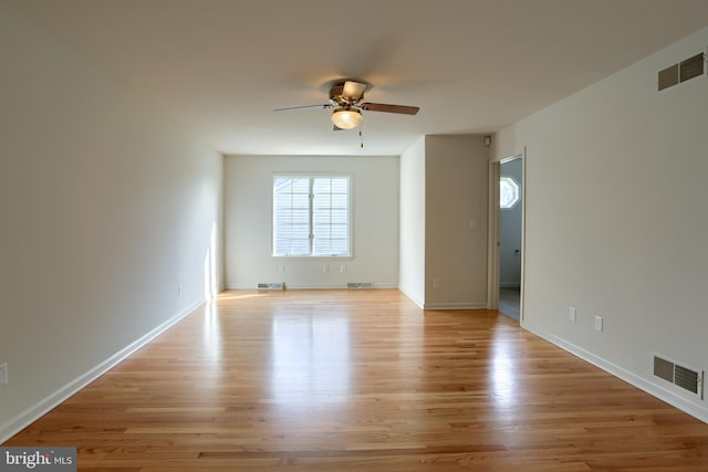 empty room with ceiling fan and light wood-type flooring