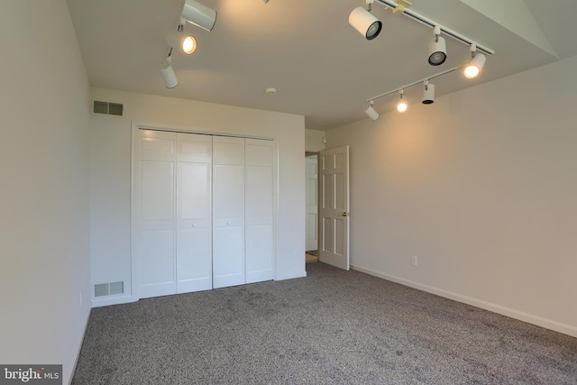 unfurnished bedroom with carpet floors and a closet