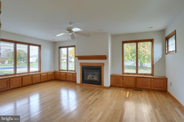 unfurnished living room featuring light hardwood / wood-style floors and ceiling fan