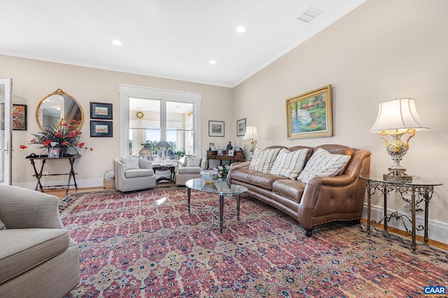 living room featuring crown molding and hardwood / wood-style flooring