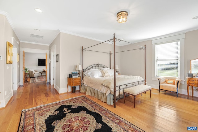 bedroom with ornamental molding and wood-type flooring