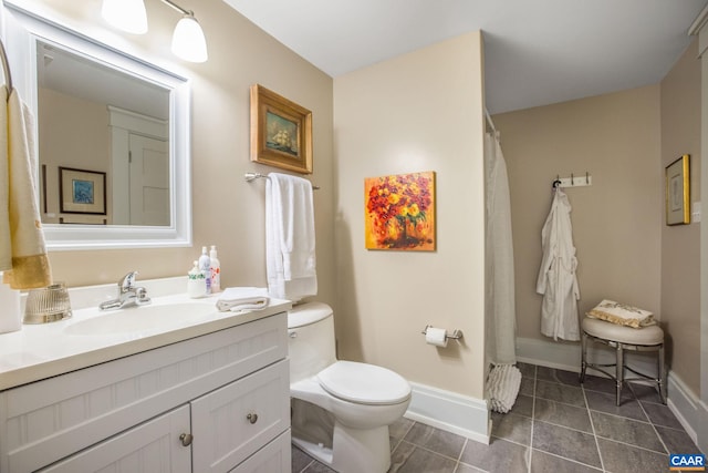 bathroom featuring toilet, vanity, tile patterned floors, and a shower with shower curtain