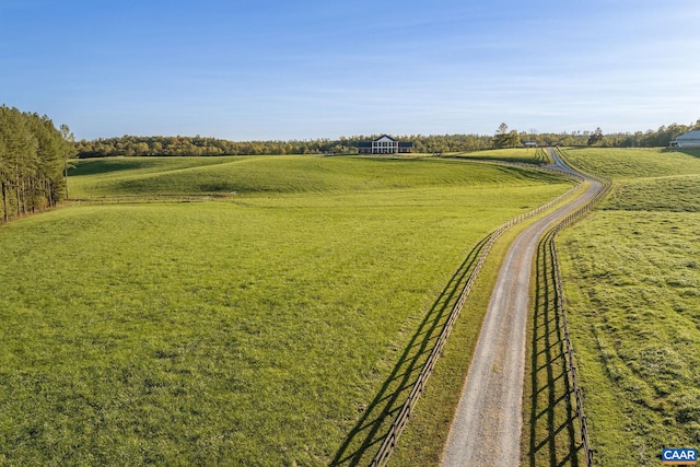 view of property's community featuring a rural view and a lawn