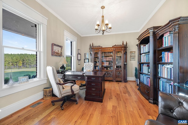 office area with an inviting chandelier, ornamental molding, and light wood-type flooring