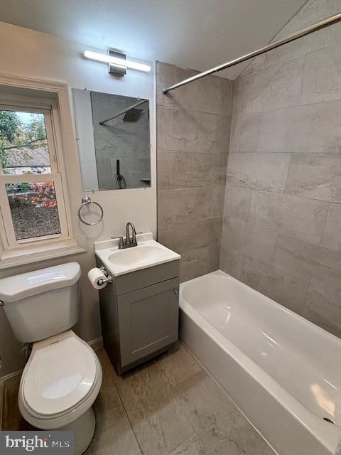 full bathroom with tiled shower / bath, vanity, and toilet