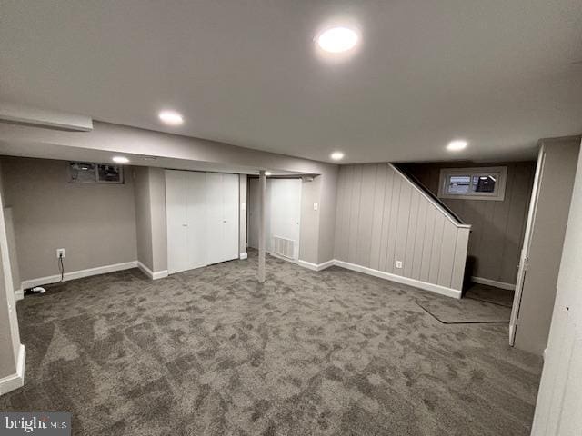 basement featuring dark colored carpet