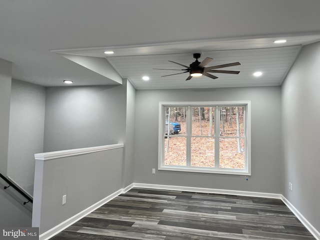 spare room featuring lofted ceiling, ceiling fan, and dark wood-type flooring