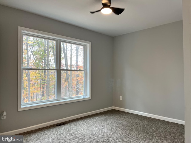 spare room with carpet flooring and ceiling fan