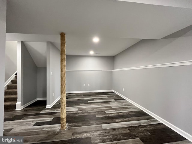 basement with dark hardwood / wood-style floors