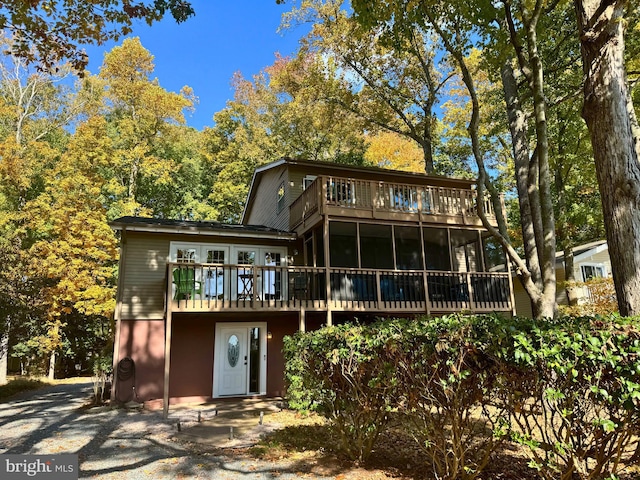 rear view of property featuring a balcony