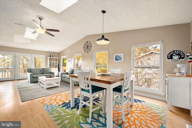 702 Ocean Pkwy, Ocean Pines, MD 21811 - dining space with a skylight, light wood-style flooring, a textured ceiling, ceiling fan, and plenty of natural light