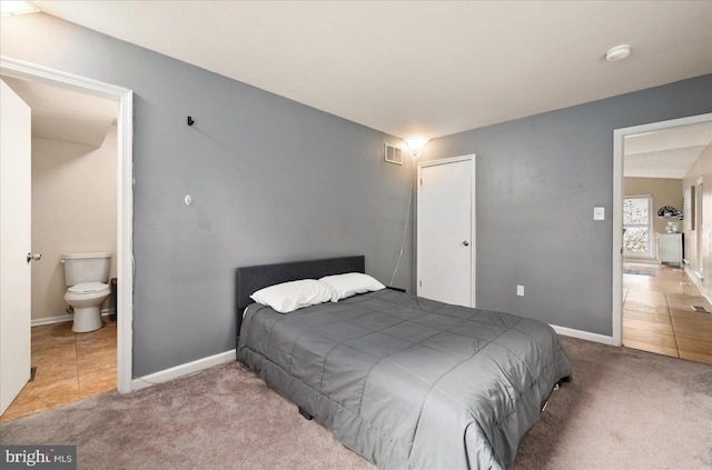 carpeted bedroom featuring a closet and ensuite bathroom