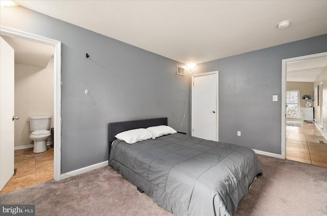 702 Ocean Pkwy, Ocean Pines, MD 21811 - tiled bedroom featuring carpet floors, baseboards, and ensuite bath
