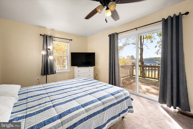 bedroom with ceiling fan, multiple windows, carpet floors, and access to outside