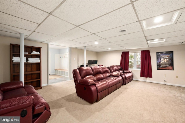 cinema room with a paneled ceiling and carpet floors