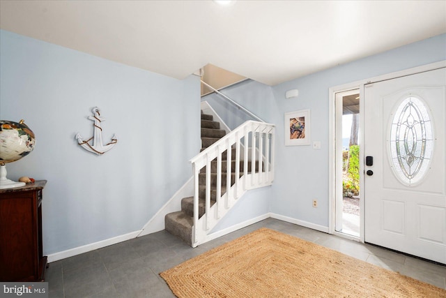 tiled entrance foyer featuring a healthy amount of sunlight