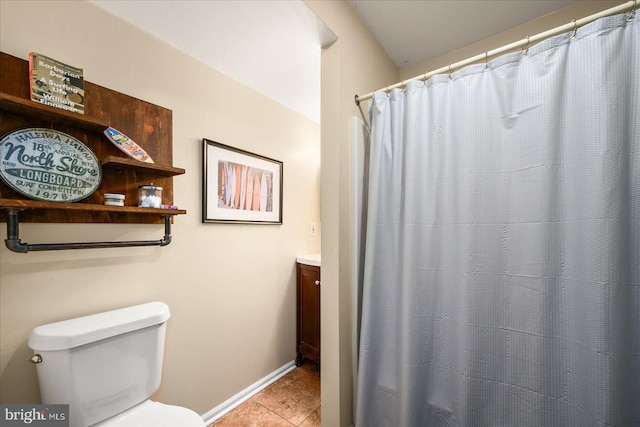 bathroom featuring toilet, vanity, and tile patterned flooring