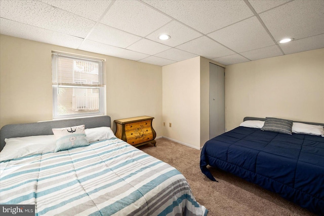 bedroom featuring a paneled ceiling and carpet