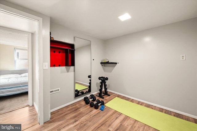 workout room with hardwood / wood-style floors