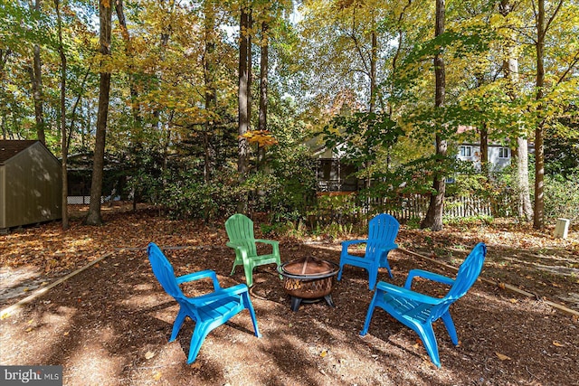 702 Ocean Pkwy, Ocean Pines, MD 21811 - view of yard with an outdoor fire pit, a storage unit, and an outdoor structure