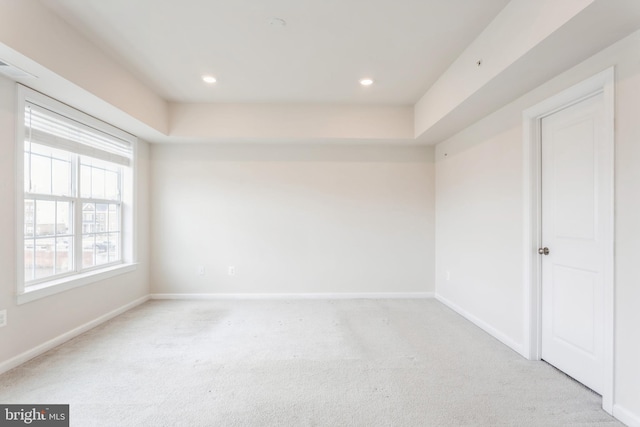 unfurnished room with recessed lighting, baseboards, and light colored carpet