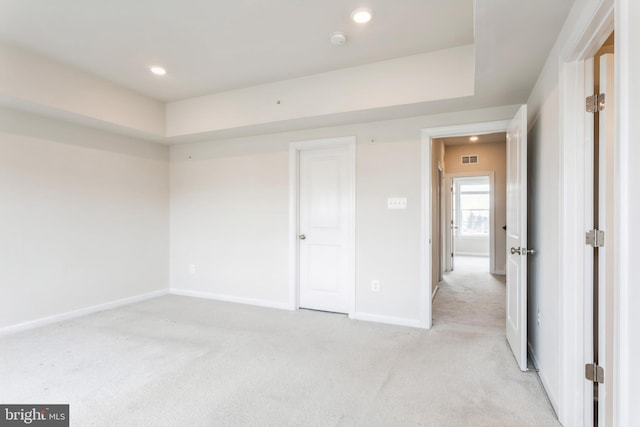 unfurnished bedroom featuring light carpet, recessed lighting, visible vents, and baseboards