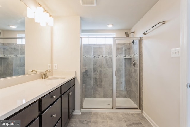 full bath featuring a stall shower, visible vents, baseboards, tile patterned floors, and vanity