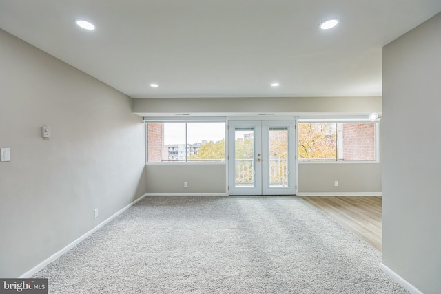 spare room featuring light hardwood / wood-style floors and french doors