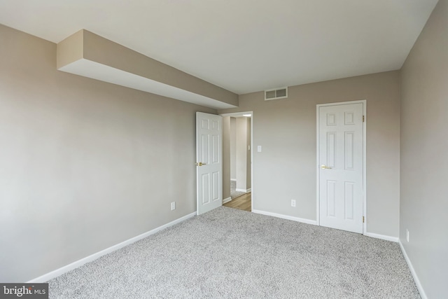 unfurnished bedroom featuring light carpet