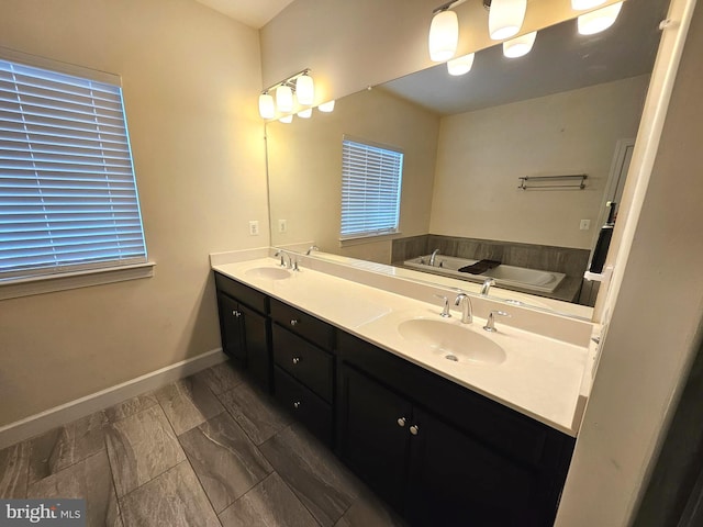 bathroom with vanity and a tub