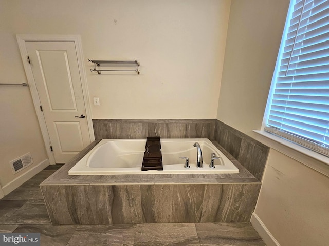 bathroom featuring a relaxing tiled tub