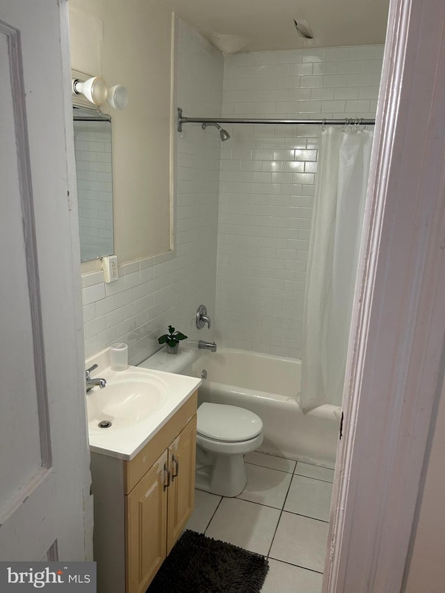 full bathroom featuring shower / bathtub combination with curtain, tile walls, toilet, vanity, and tile patterned flooring