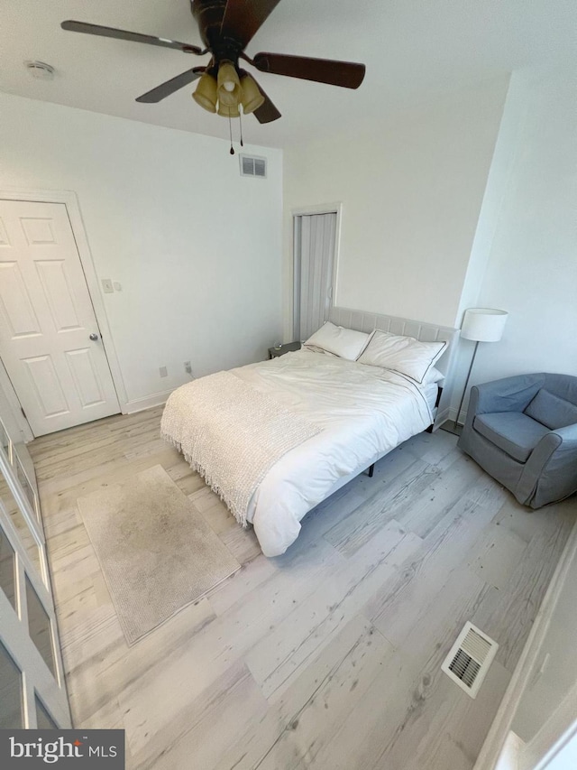 bedroom with light wood-type flooring and ceiling fan