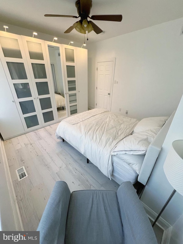 bedroom featuring light hardwood / wood-style floors and ceiling fan