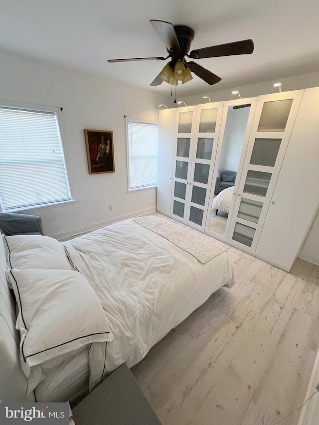 bedroom with light hardwood / wood-style floors and ceiling fan