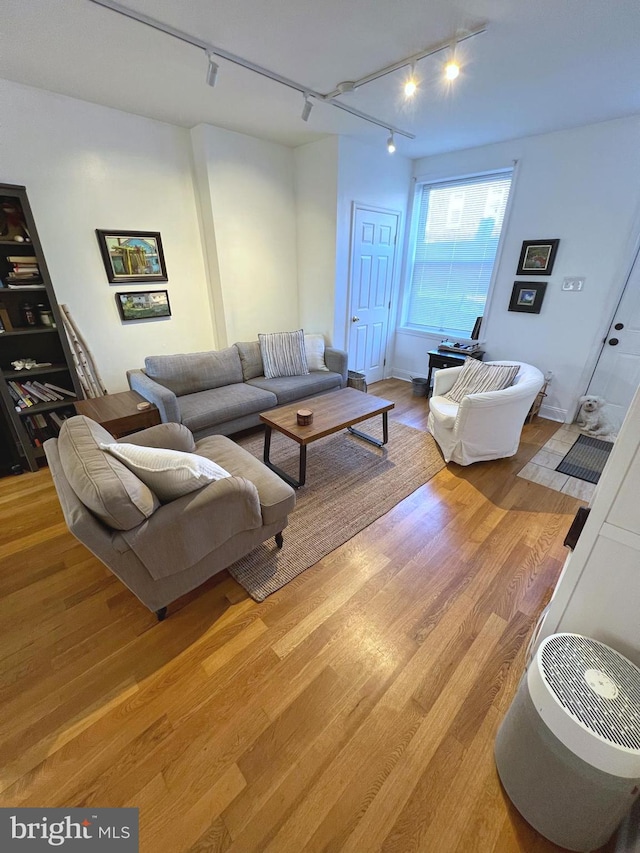 living room featuring track lighting and light hardwood / wood-style floors