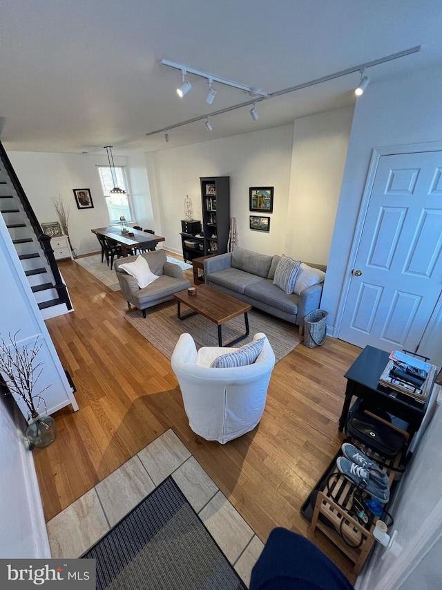 living room featuring track lighting and hardwood / wood-style flooring