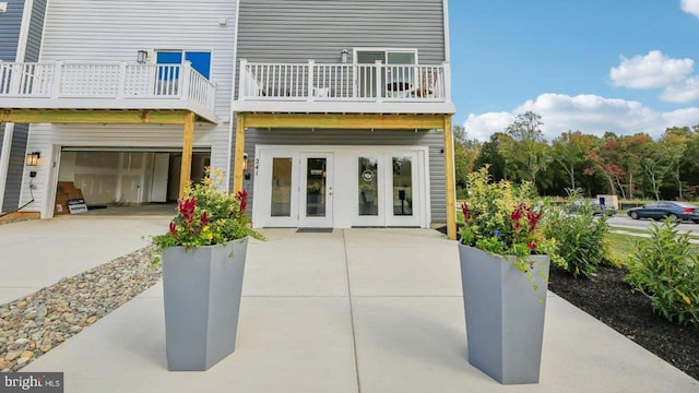 exterior space featuring a balcony and french doors