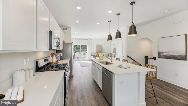 kitchen with white cabinetry, a center island with sink, stainless steel appliances, and sink