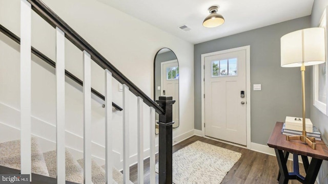 foyer with dark hardwood / wood-style floors